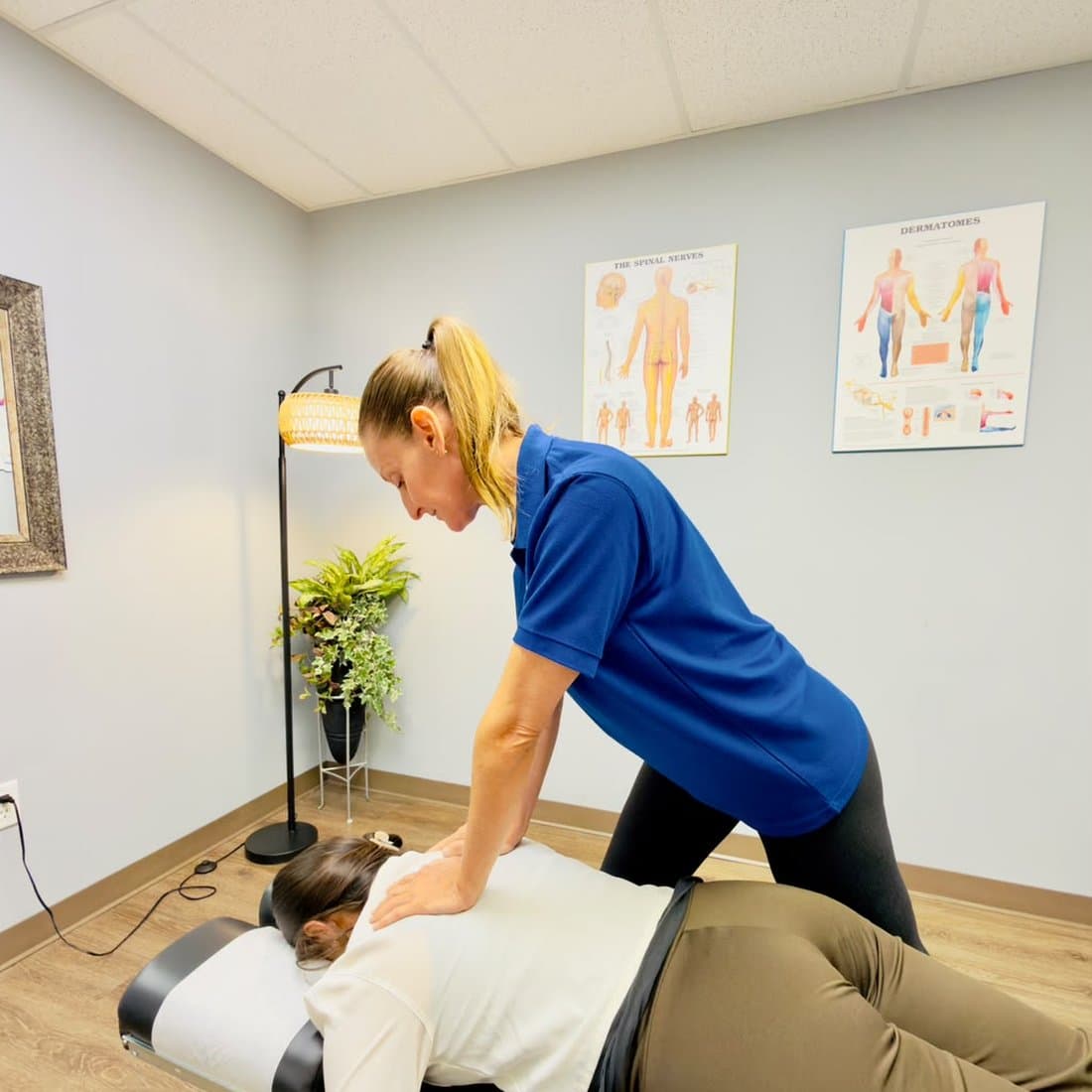 Dr. Tiffany Rose Lukas performing a spinal adjustment on a patient at Planet Health Care