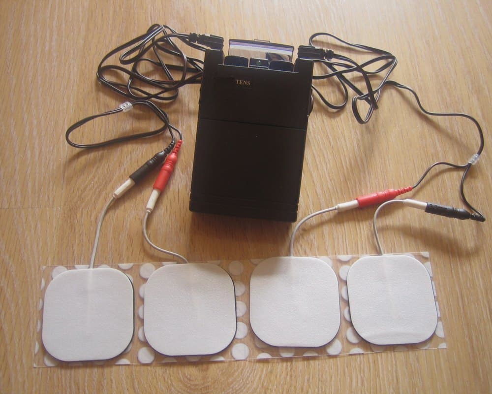 A portable TENS unit with lead wires and electrode pads